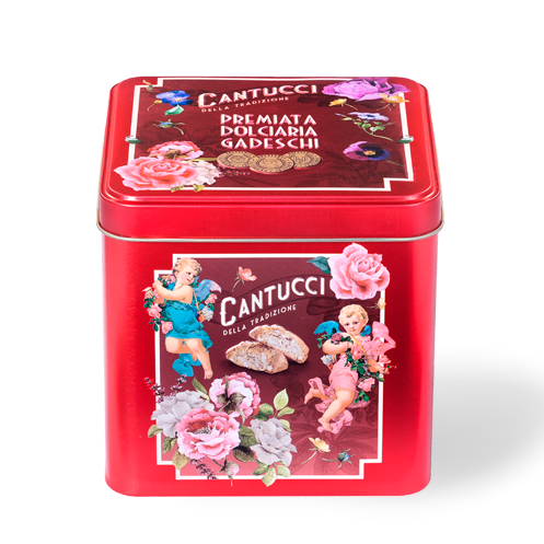 Decorative red tin box with vintage-style design featuring cherubs, flowers, and text on a white background.